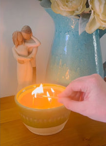 Beeswax candle in locally produced pottery